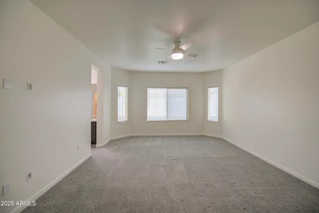 an empty room with windows and closet