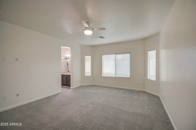 an empty room with windows and closet