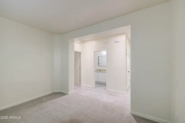 a bathroom with a granite countertop sink a toilet and mirror