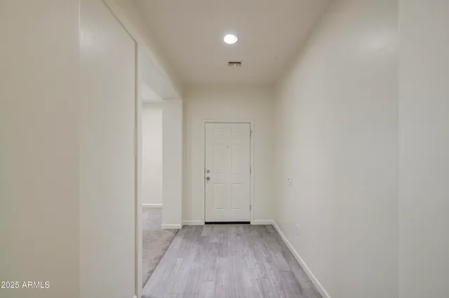 a view of a room with wooden floor