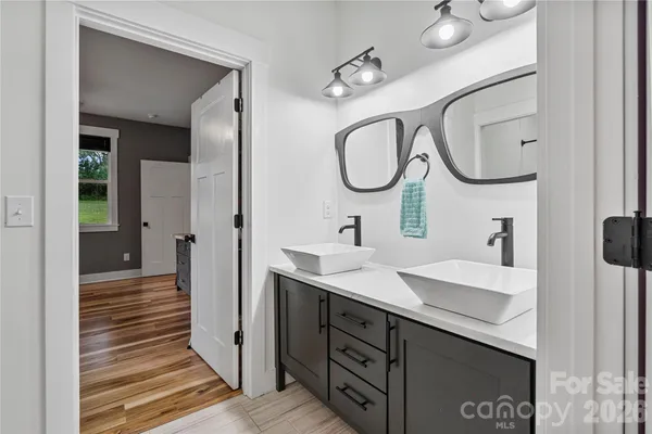 a spacious bathroom with a granite countertop sink and a mirror