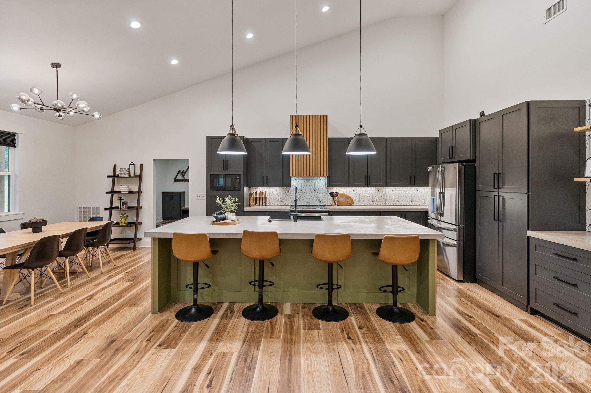 13546 State Highway 55 York, SC 29745 - Photo 20 of 48 a kitchen with stainless steel appliances kitchen island granite countertop a table chairs and a wooden floor