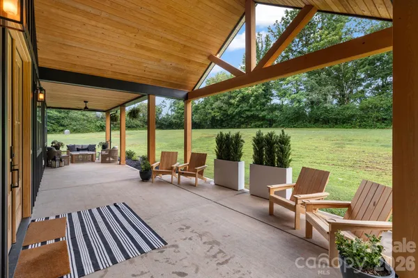 a building outdoor space with patio furniture and potted plants