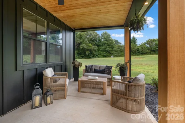 a kitchen with stainless steel appliances kitchen island granite countertop a table chairs and a stove