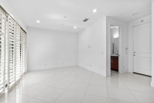an empty room with a natural light and entryway
