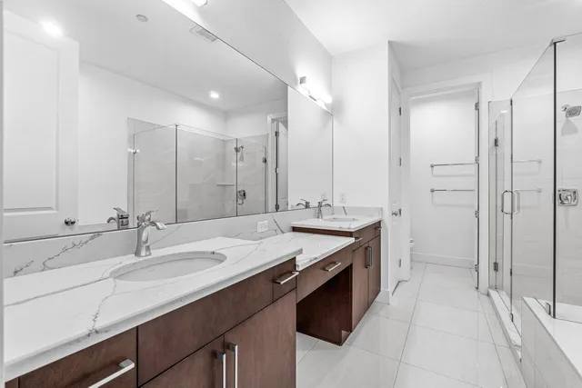 a bathroom with a sink double vanity and a mirror