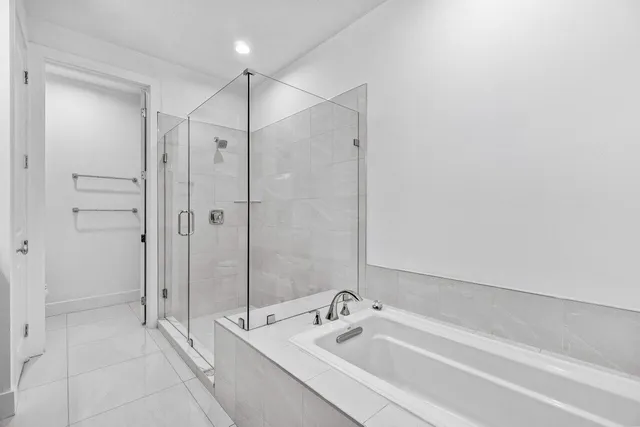 a bathroom with a bathtub and a shower