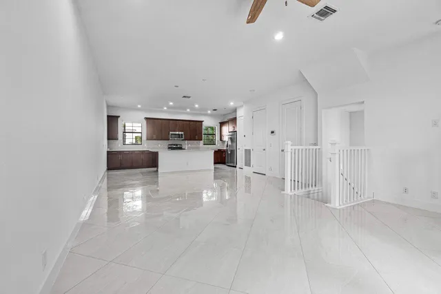 a view of a living room and kitchen with furniture appliances
