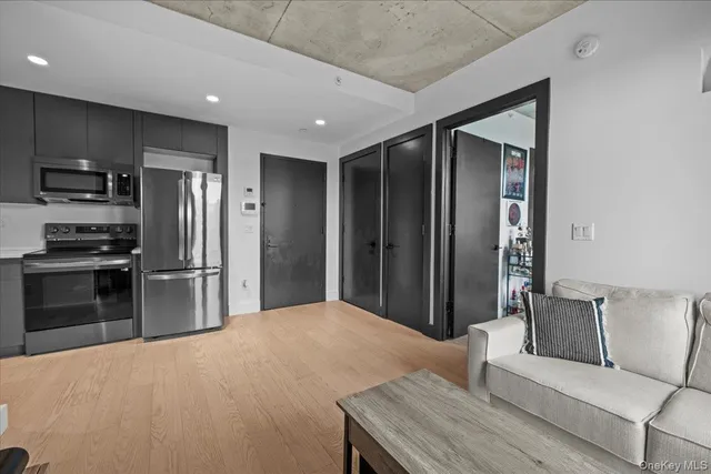 a kitchen with kitchen island stainless steel appliances a refrigerator and a stove top oven