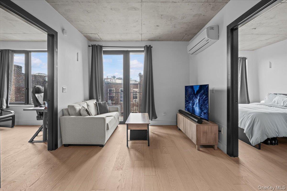 458 East 25th Street, Unit 305 Brooklyn, NY 11226 - Photo 7 of 14 a living room with furniture and a flat screen tv