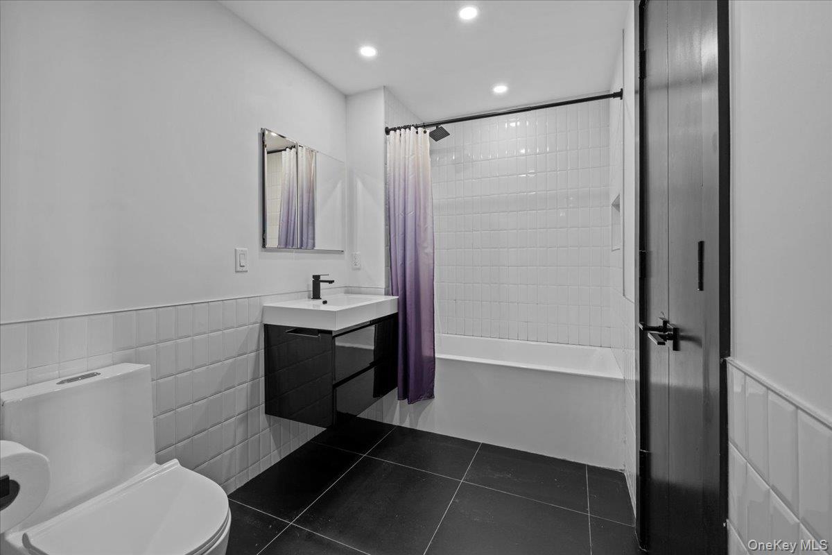 458 East 25th Street, Unit 305 Brooklyn, NY 11226 - Photo 8 of 14 a bathroom with a sink toilet and shower