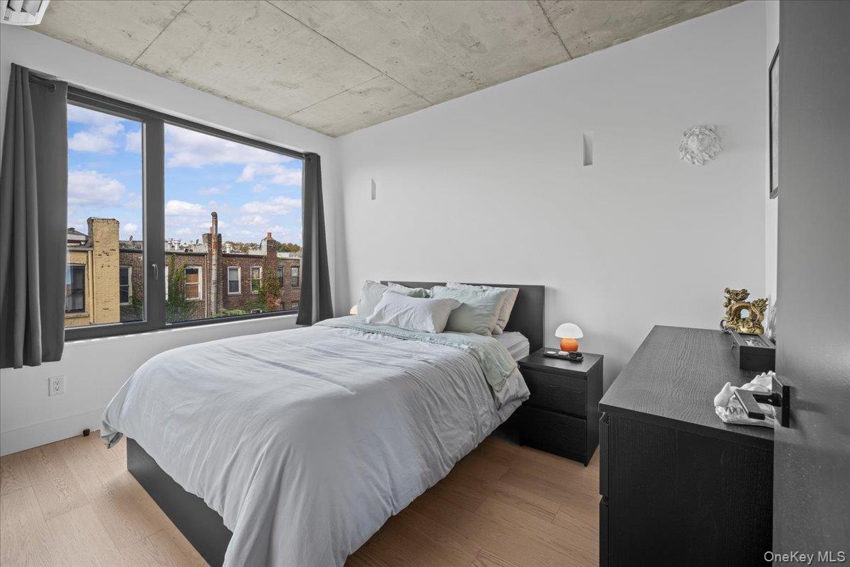 458 East 25th Street, Unit 305 Brooklyn, NY 11226 - Photo 9 of 14 a bedroom with a bed and a large window
