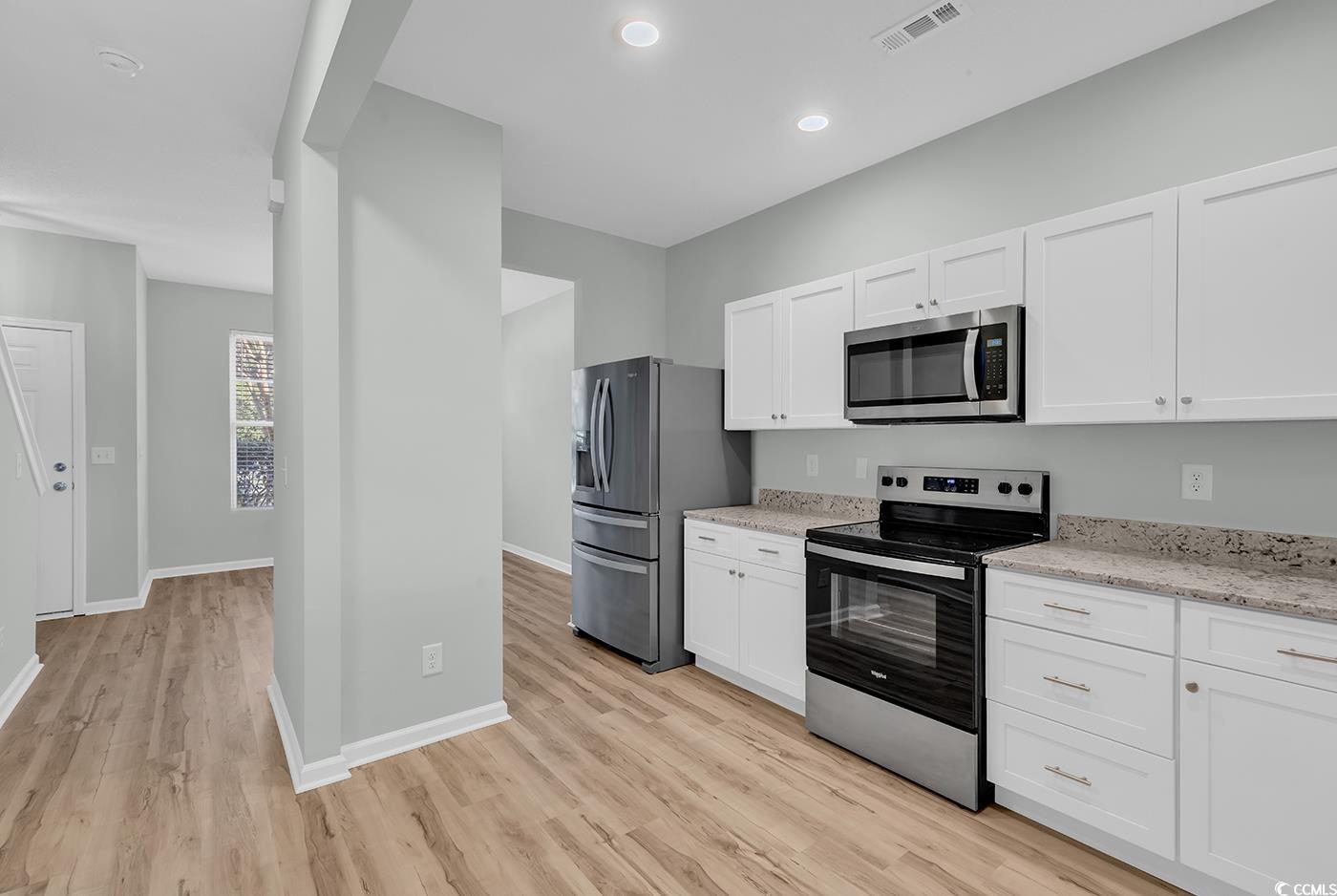 308 Kiskadee Loop, Unit E Conway, SC 29526 - Photo 11 of 36 Kitchen with stainless steel appliances, white cabinetry, light stone counters, and recessed lighting