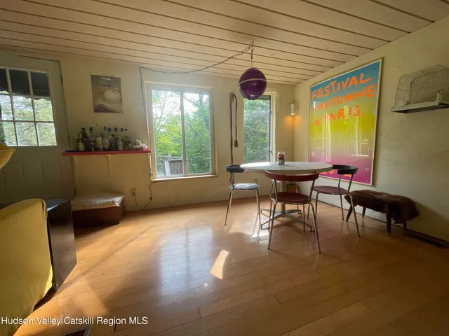a dining room with furniture and a window