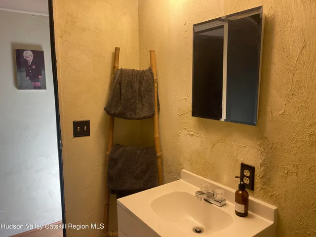 a bathroom with a sink and mirror
