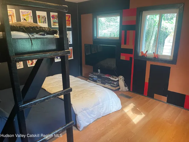 a bedroom with window and bed