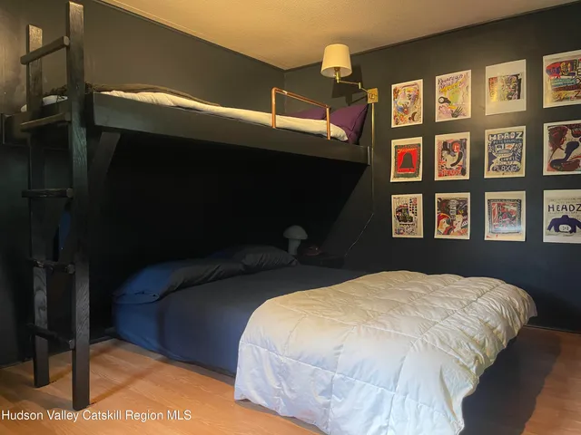 a bed sitting in a bedroom next to a window