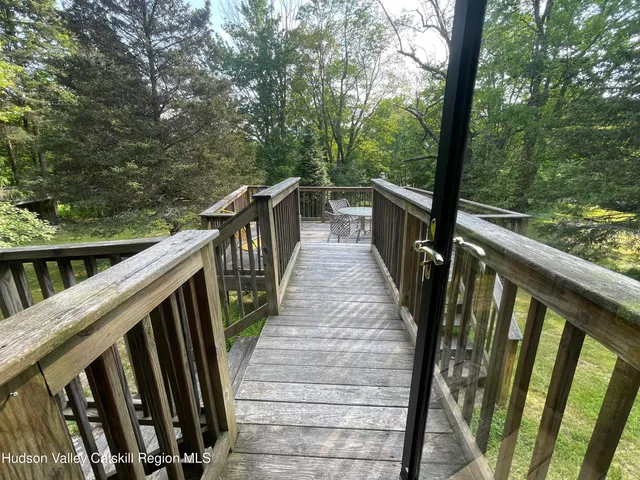 a view of a balcony with wooden floor and stairs