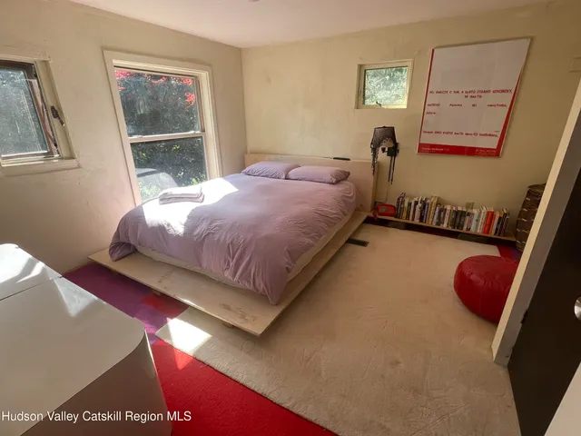 a bed sitting in a bedroom next to a window