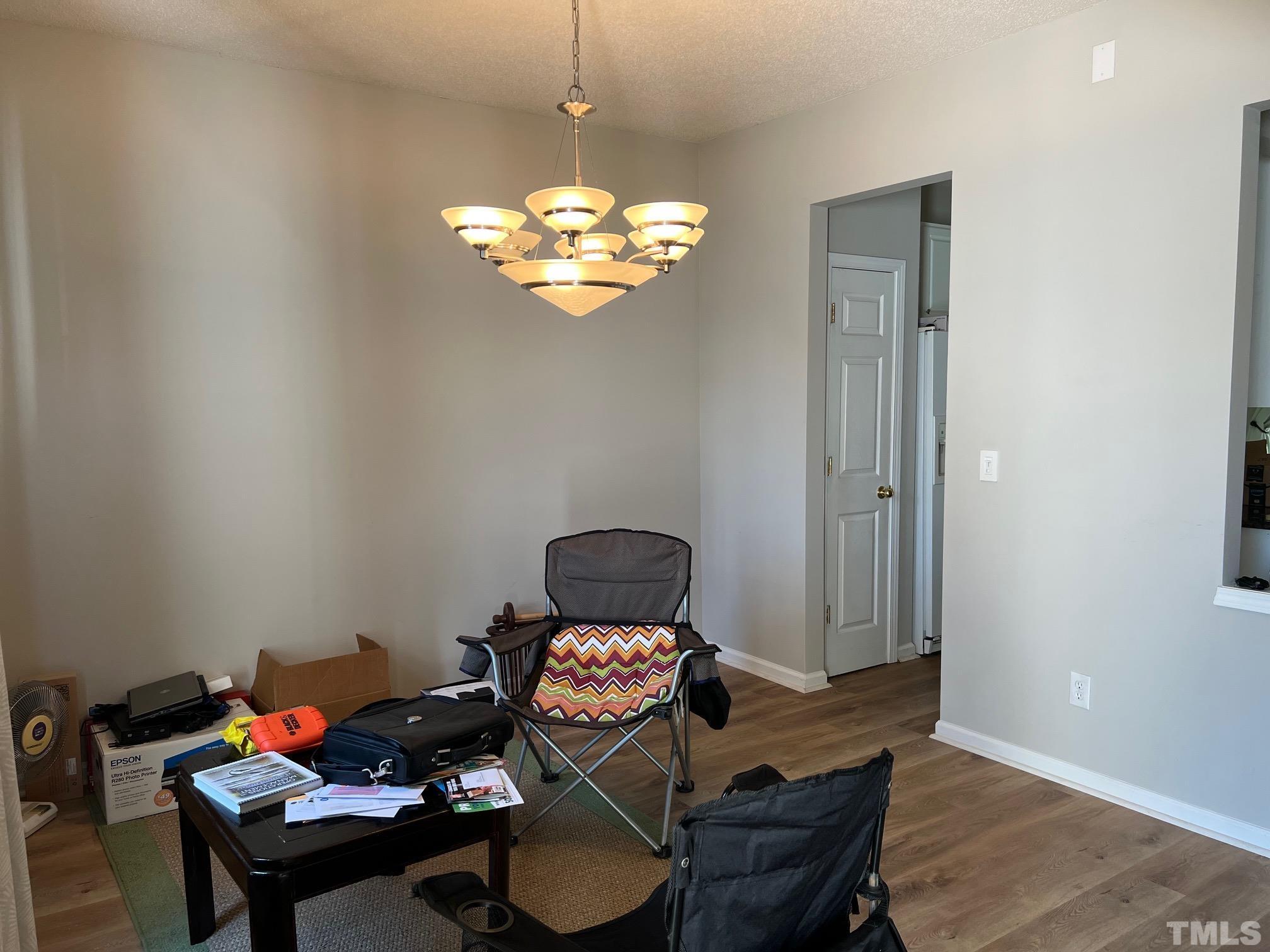 302 Durston Loop Morrisville, NC 27560 - Photo 12 of 21 a living room with furniture and a chandelier