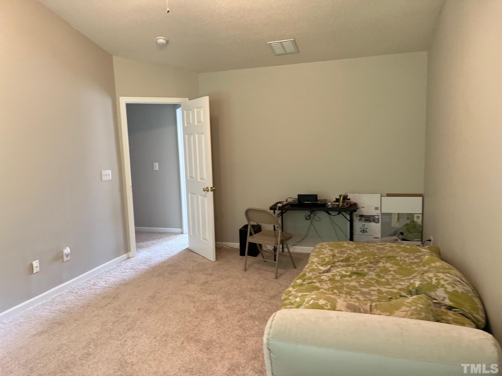 302 Durston Loop Morrisville, NC 27560 - Photo 13 of 21 a bed room with a bed and a chair