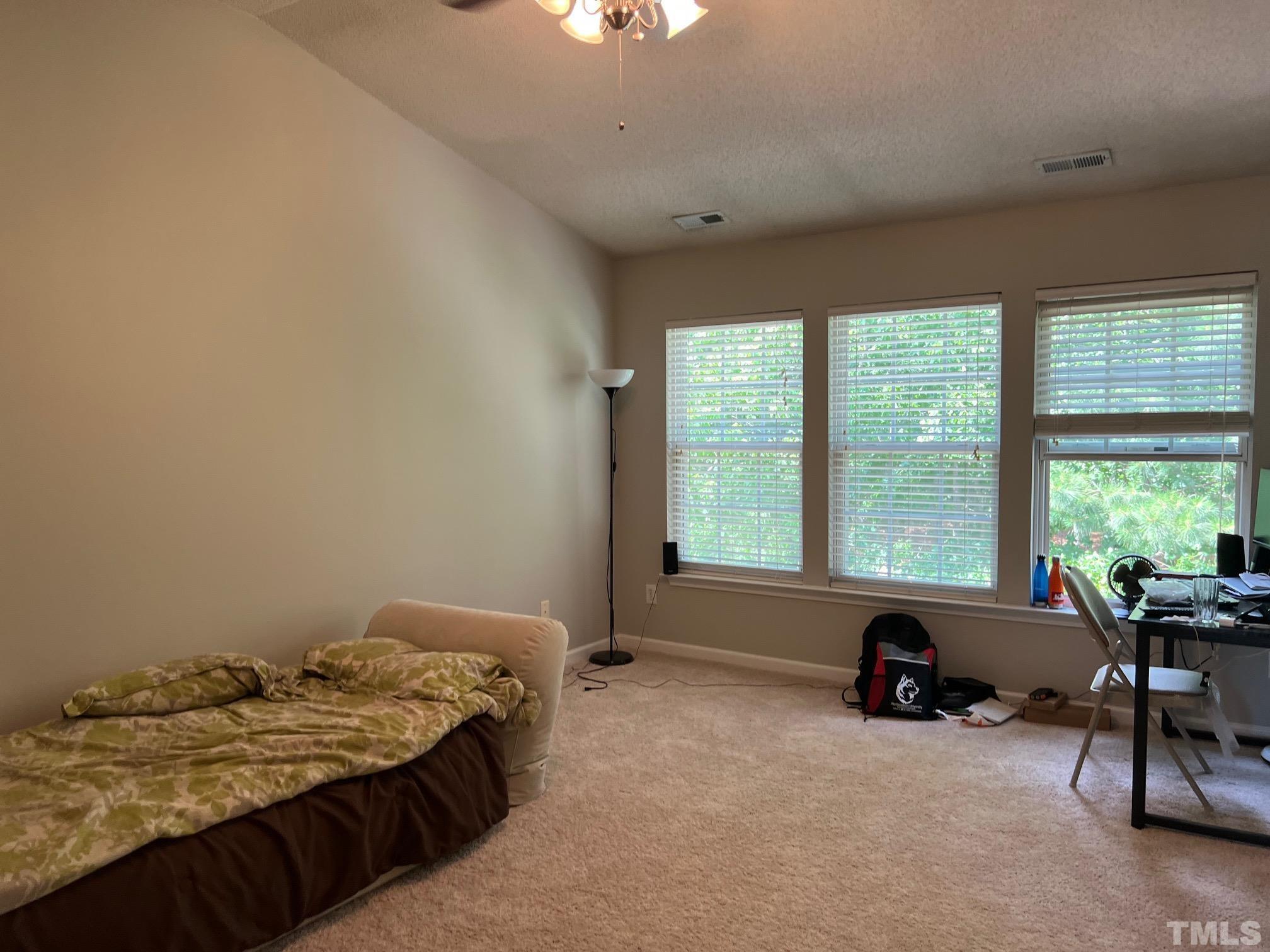 302 Durston Loop Morrisville, NC 27560 - Photo 14 of 21 a bedroom with a bed and a table chair