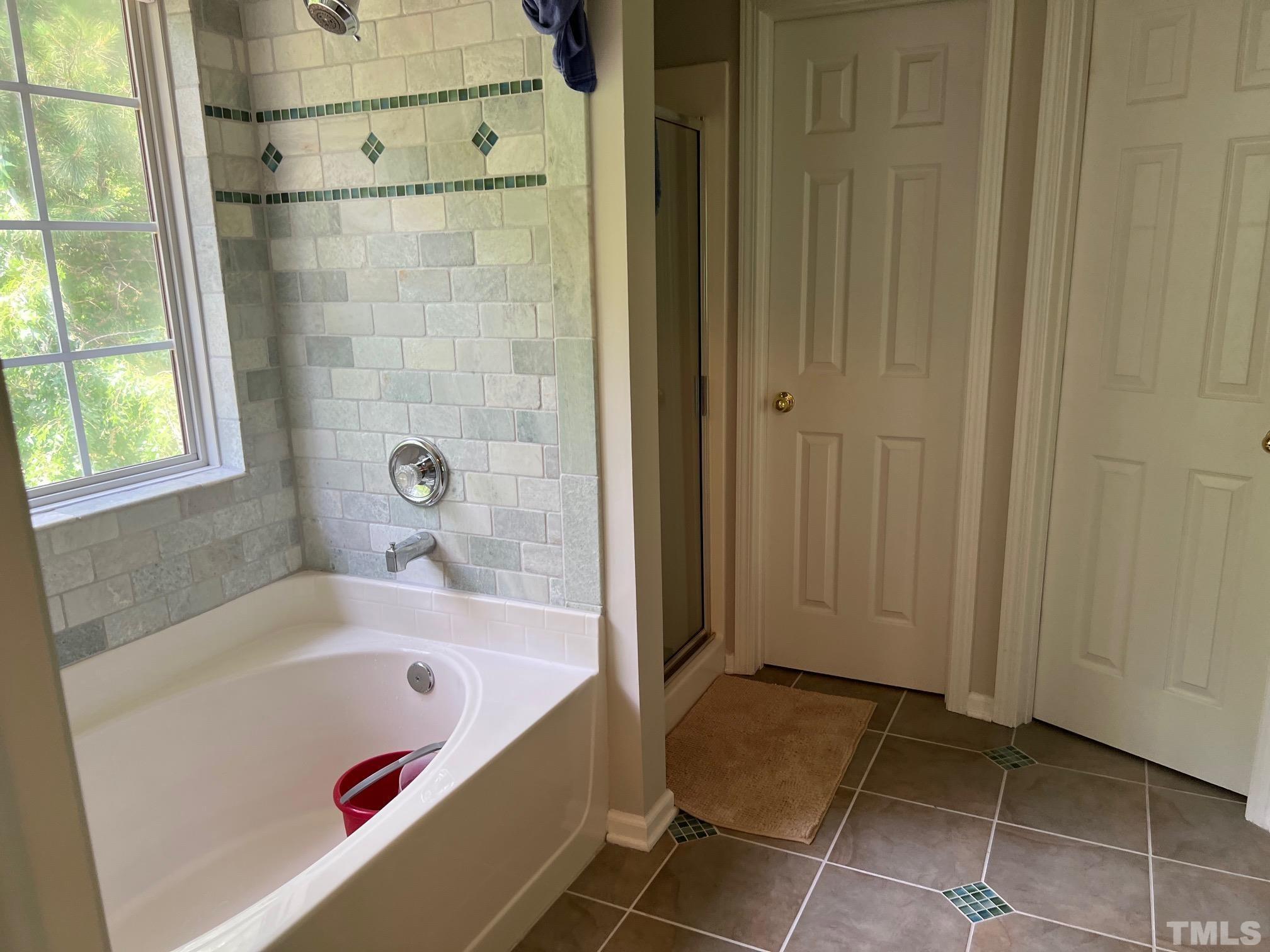 302 Durston Loop Morrisville, NC 27560 - Photo 15 of 21 a bathroom with a bathtub and shower