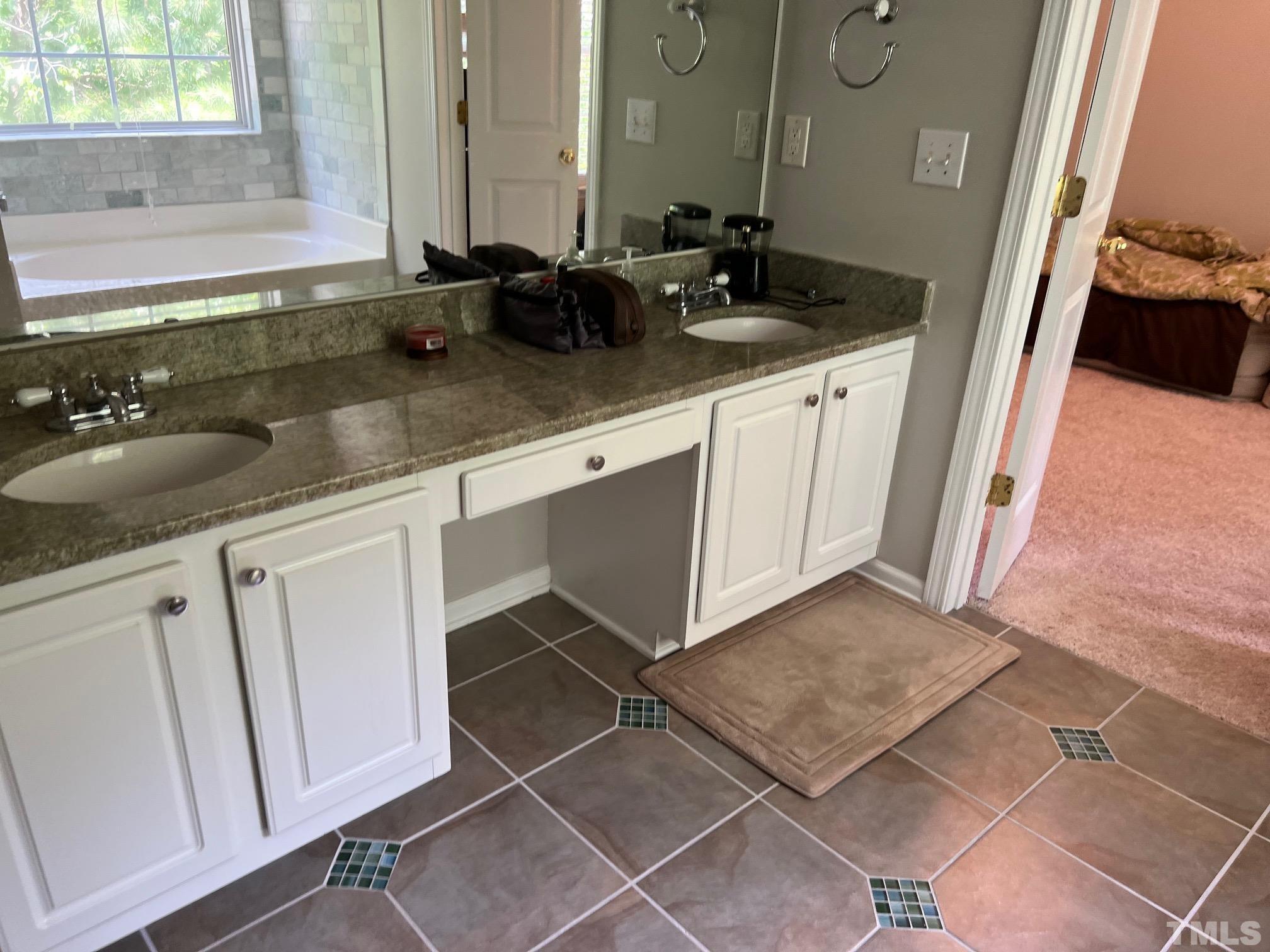 302 Durston Loop Morrisville, NC 27560 - Photo 4 of 21 a bathroom with a sink and a mirror