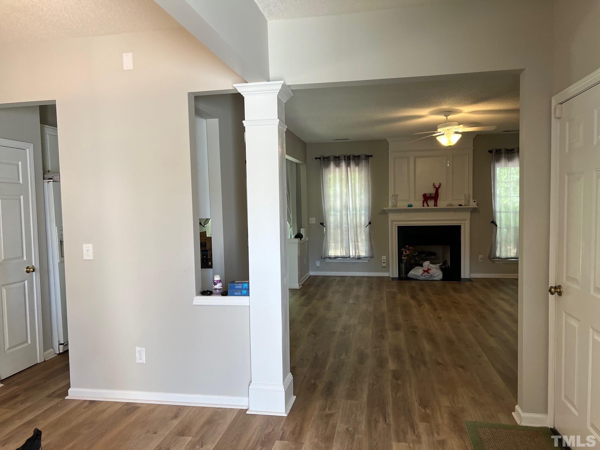 302 Durston Loop Morrisville, NC 27560 - Photo 8 of 21 wooden floor in an empty room with a fireplace