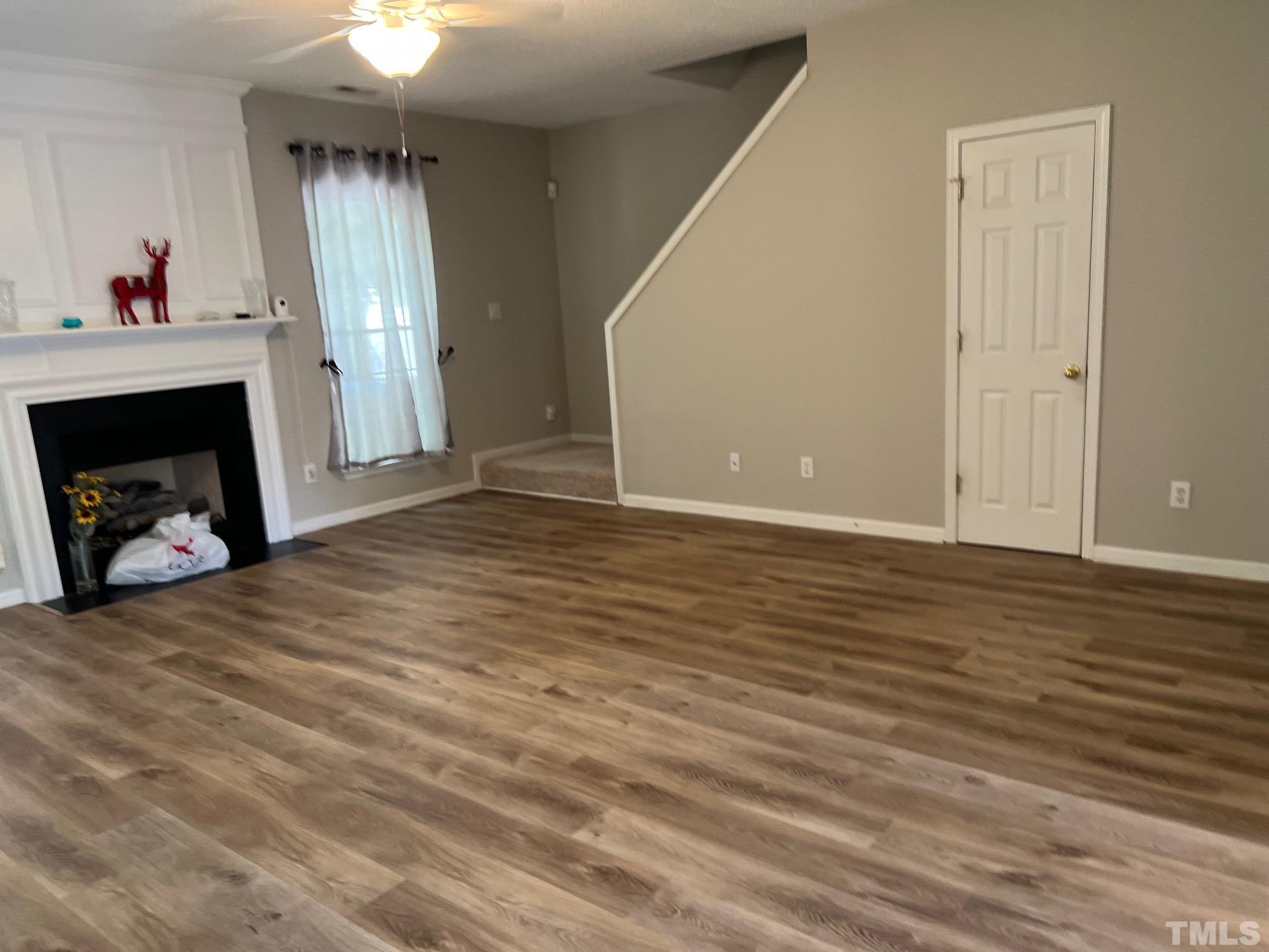 302 Durston Loop Morrisville, NC 27560 - Photo 10 of 21 a view of an empty room with wooden floor and a window