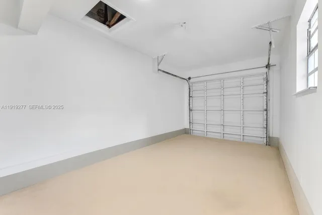 an empty room with a empty space and windows