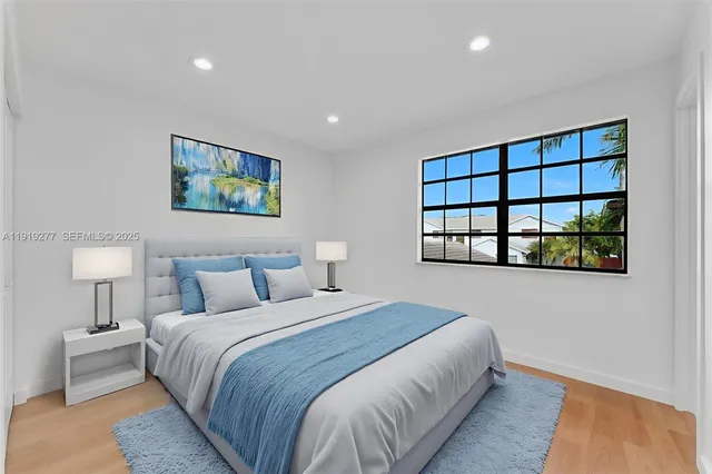 a bedroom with a bed and a painting on the wall