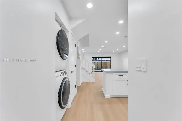 a view of kitchen with sink and refrigerator