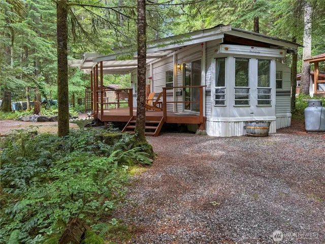 a view of a house with yard and sitting area