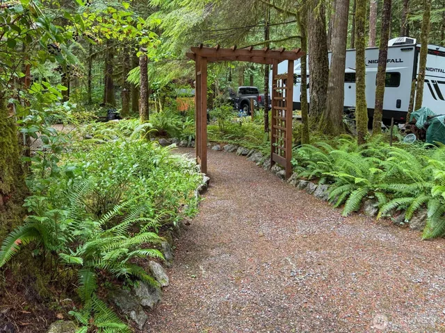 a backyard of a house with lots of green space and garden