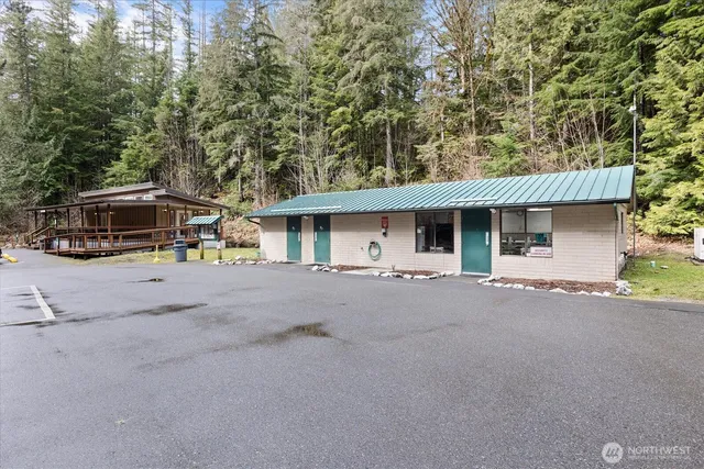 a view of a house with a patio and a yard