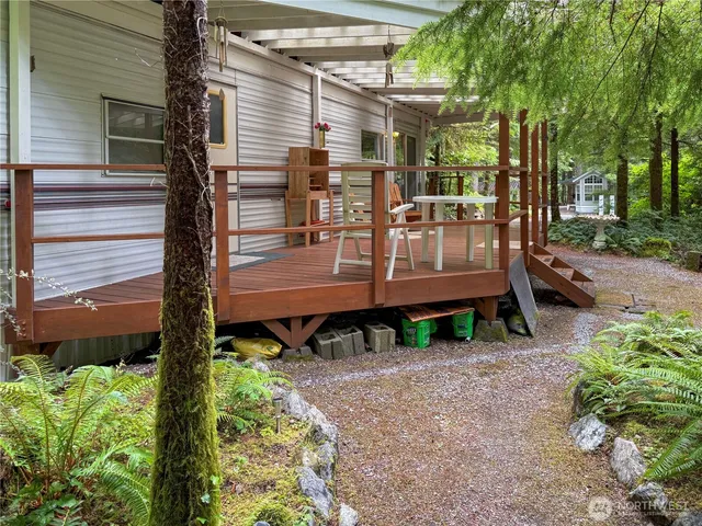 a view of a back yard of the house with a patio
