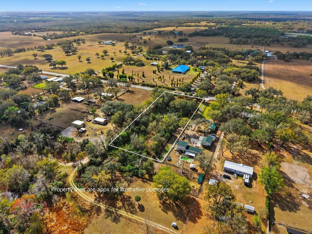 an aerial view of a houses with a lake