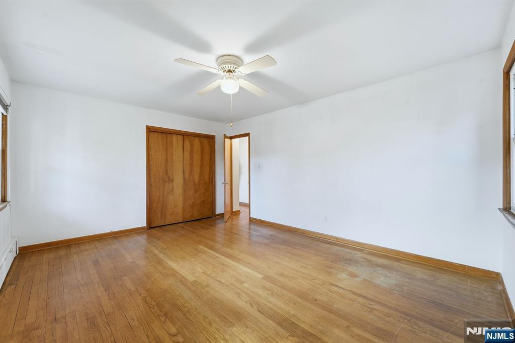 5 Dogwood Road Netcong, NJ 07857 - Photo 16 of 35 an empty room with wooden floor fan and windows