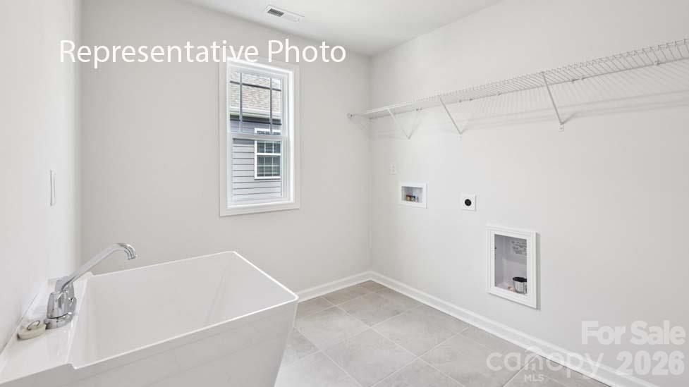 7621 Bainbridge Road Sherrills Ford, NC 28673 - Photo 33 of 34 a bathroom with a bathtub and a window