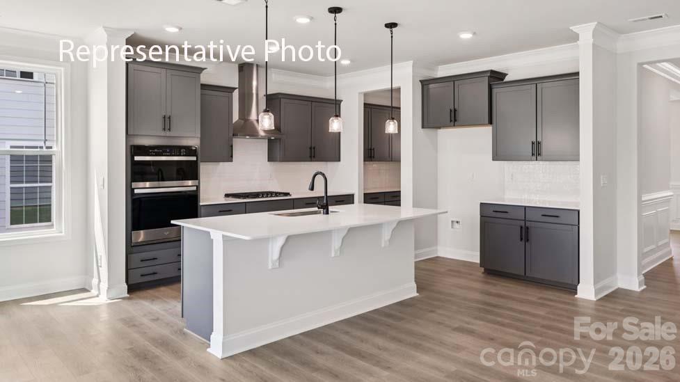 7621 Bainbridge Road Sherrills Ford, NC 28673 - Photo 6 of 34 a kitchen with kitchen island white cabinets and stainless steel appliances