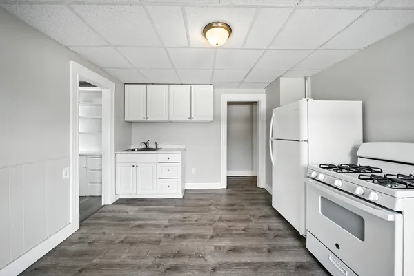 a kitchen with white cabinets and stainless steel appliances