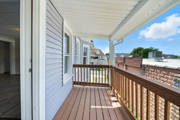 a view of balcony with wooden floor