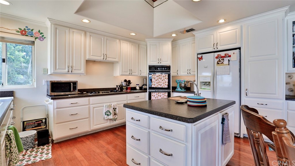 1102 Eucalyptus Drive El Cajon, CA 92020 - Photo 16 of 63 a kitchen with stainless steel appliances granite countertop a sink stove and refrigerator