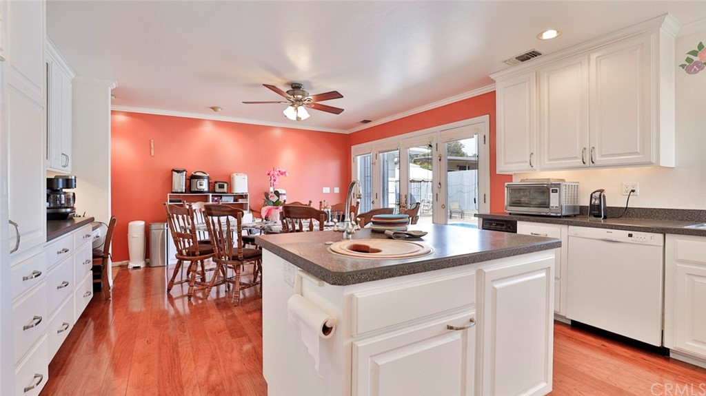 1102 Eucalyptus Drive El Cajon, CA 92020 - Photo 17 of 63 a kitchen with stainless steel appliances granite countertop a stove and white cabinets