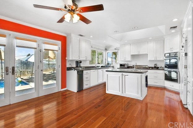 1102 Eucalyptus Drive El Cajon, CA 92020 - Photo 2 of 63 a kitchen with granite countertop stainless steel appliances and wooden floor