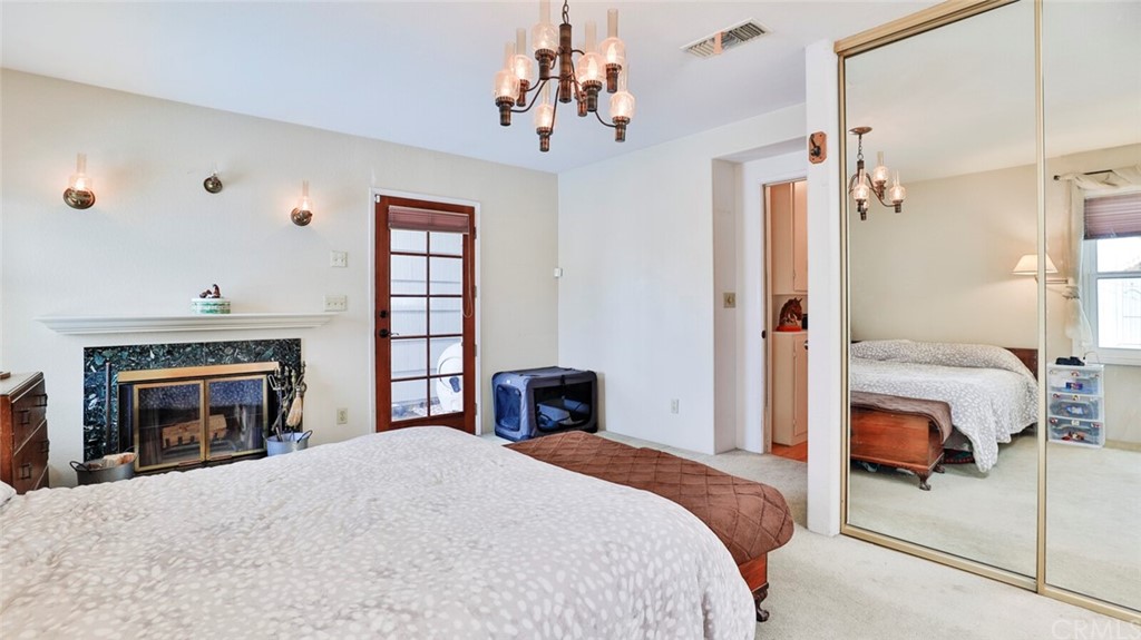 1102 Eucalyptus Drive El Cajon, CA 92020 - Photo 24 of 63 a bedroom with a bed and a fireplace