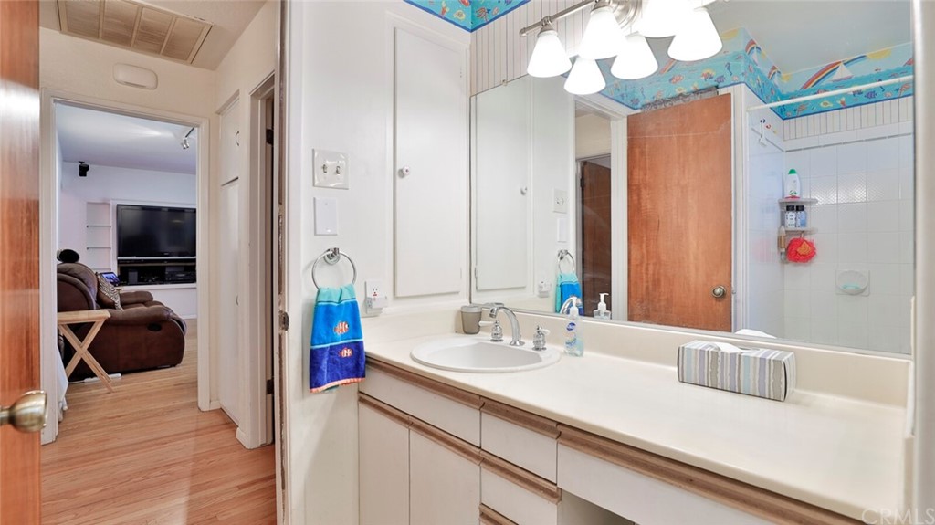 1102 Eucalyptus Drive El Cajon, CA 92020 - Photo 31 of 63 a en suite bathroom with a sink a large mirror and a shower