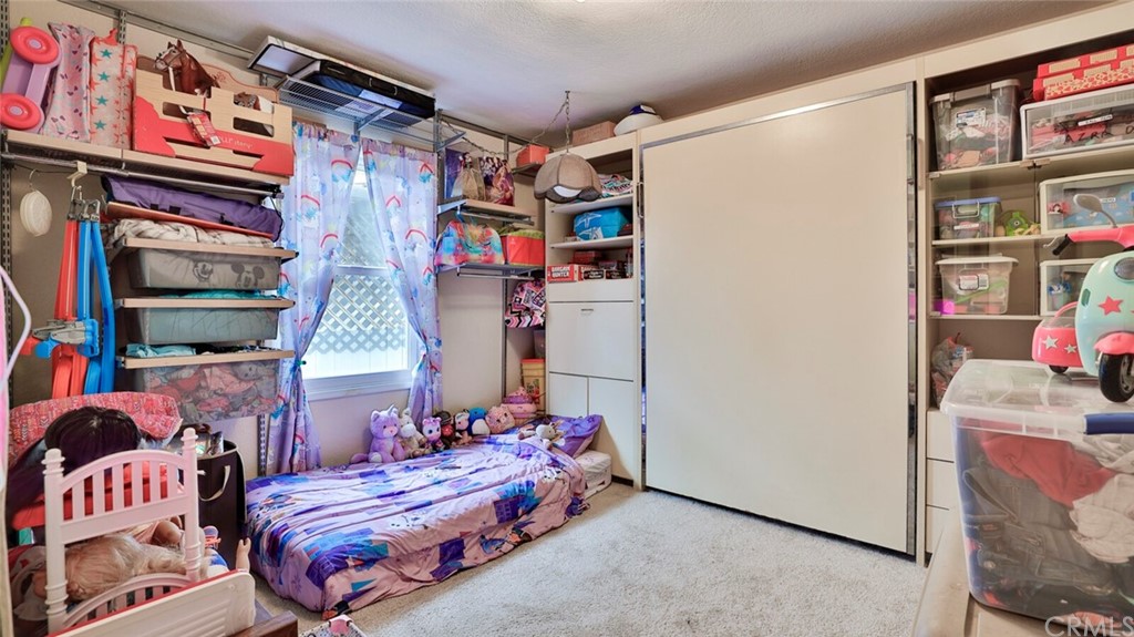1102 Eucalyptus Drive El Cajon, CA 92020 - Photo 34 of 63 a bedroom with a bed and a book shelf