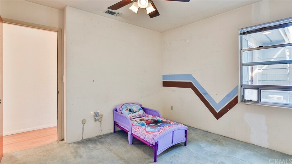 1102 Eucalyptus Drive El Cajon, CA 92020 - Photo 39 of 63 a bedroom with a bed and a chandelier